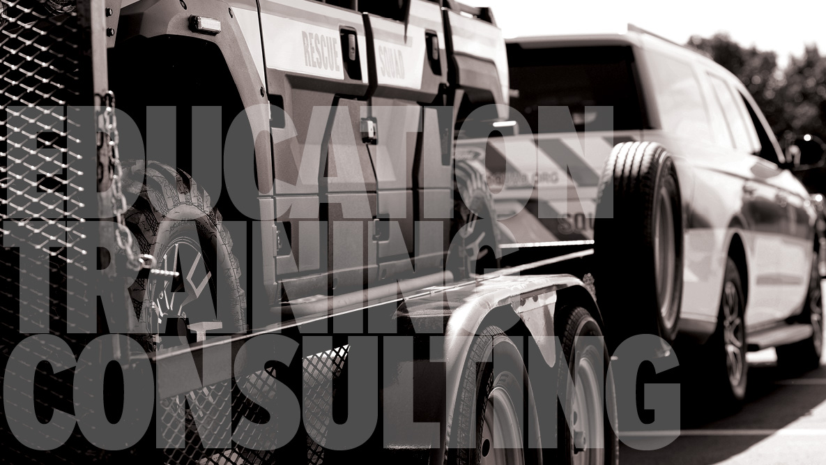 trailer with damaged vehicle being pulled by an suv